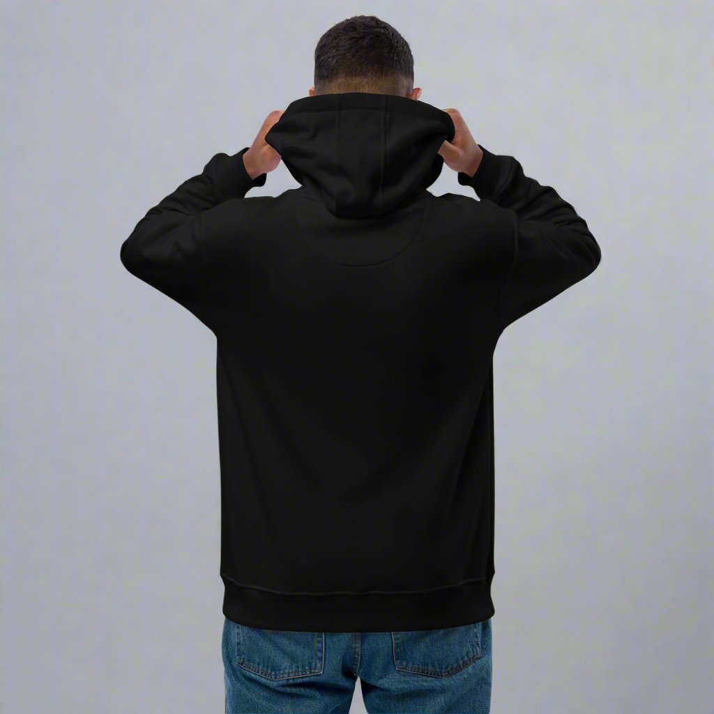 man facing backwards holding hood of black sweatshirt