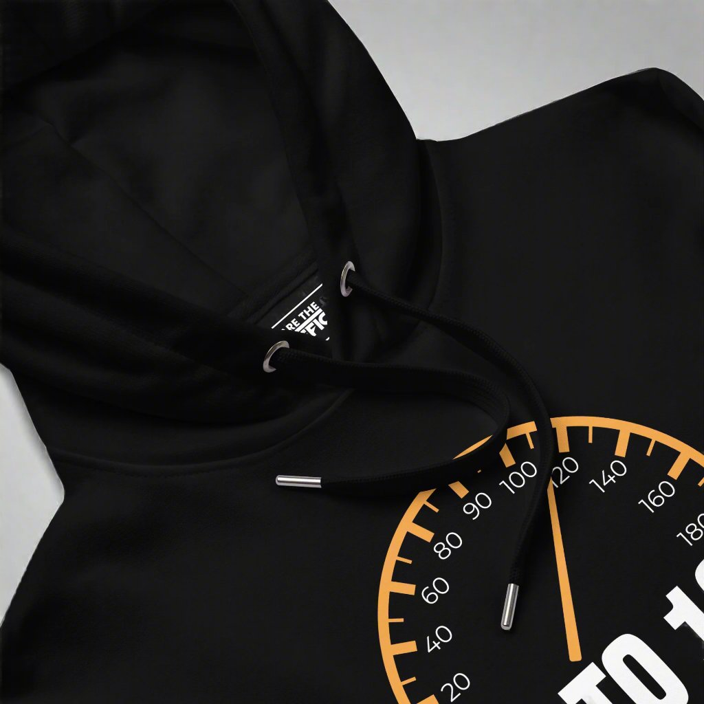 Closeup of the front of a black hoodie with a speedometer design