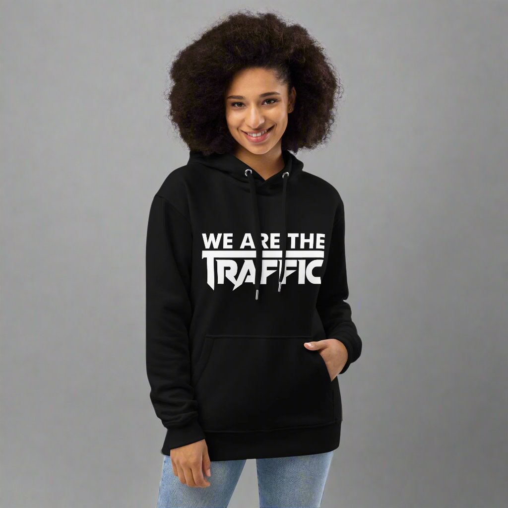 Woman wearing black hoodie with white we are the traffic logo