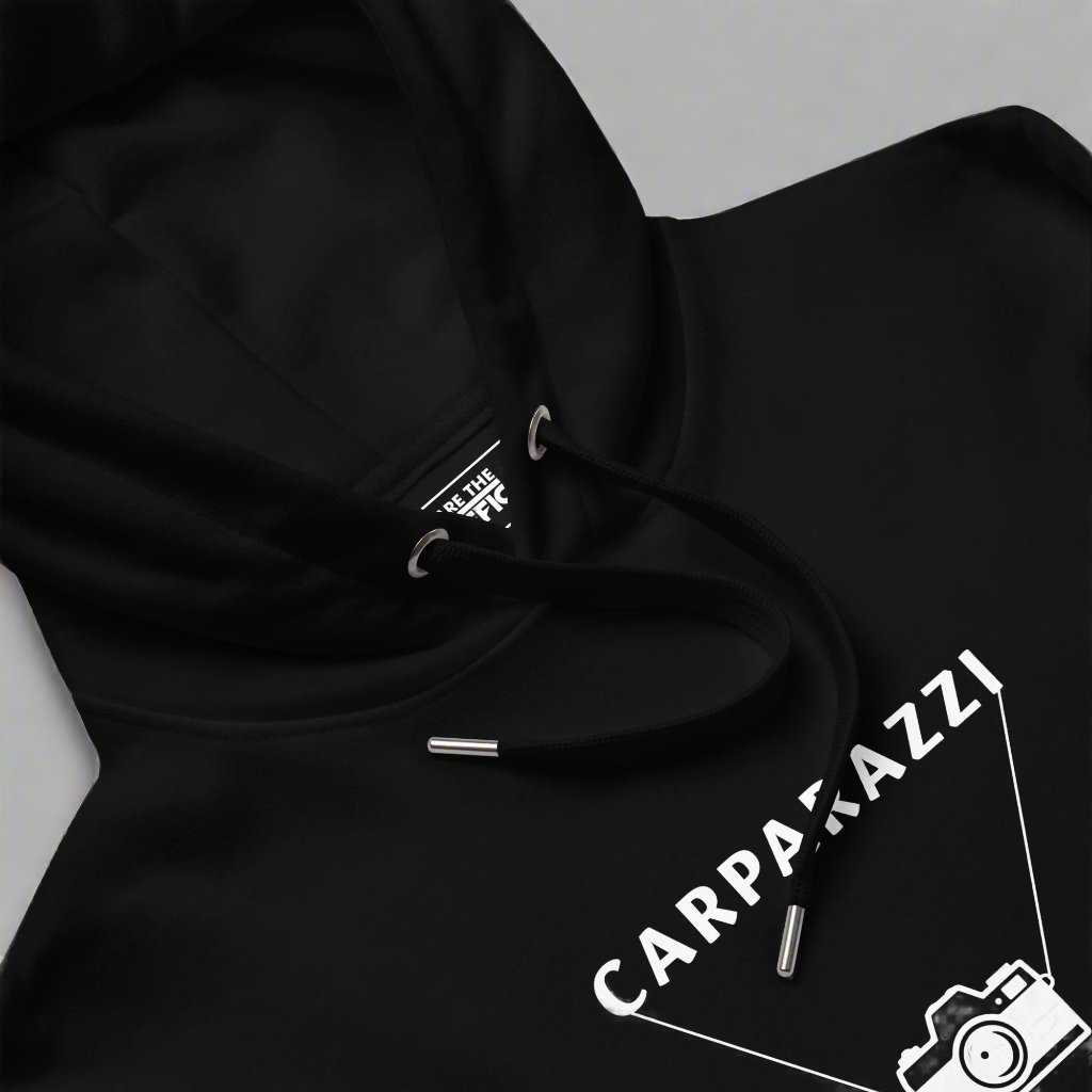 Closeup of the front of a black hoodie with carparazzi written on the front with a camera design