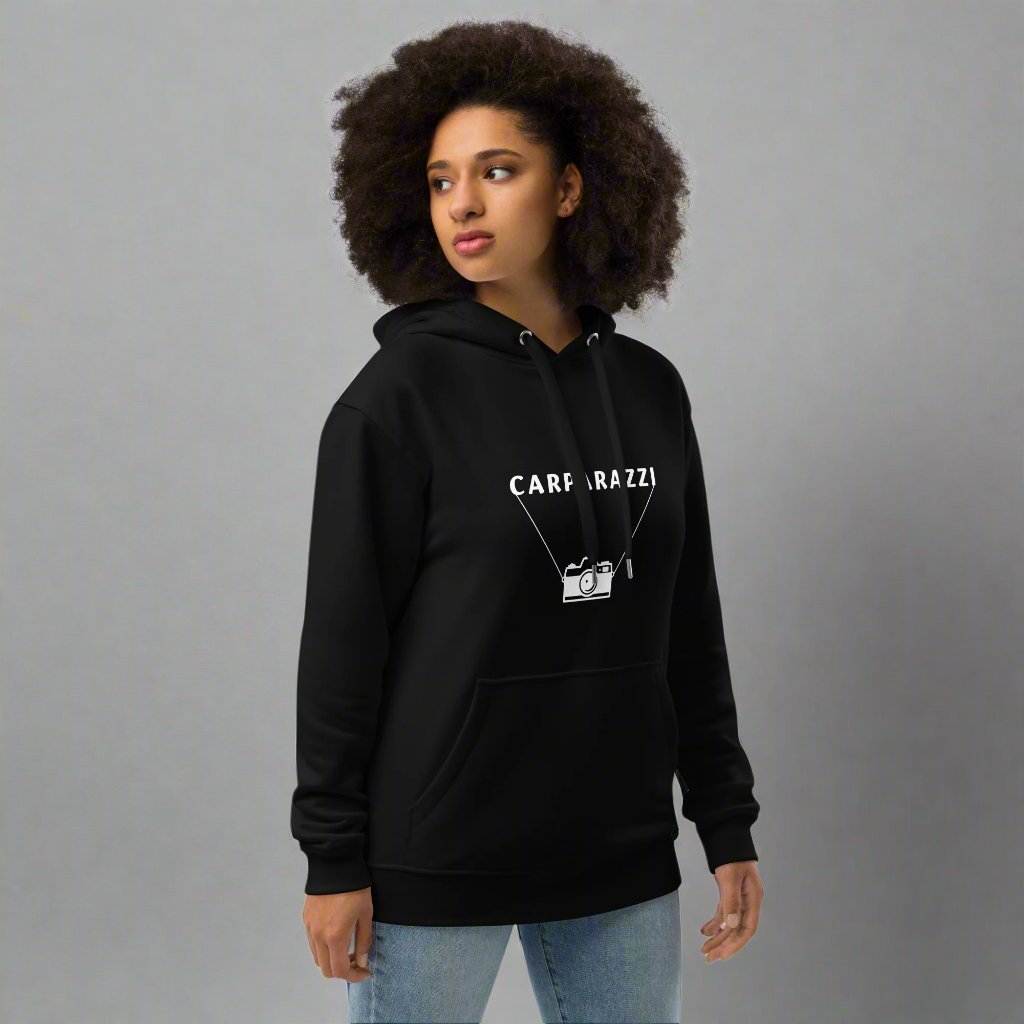 Woman wearing black hoodie with carparazzi and camera design.