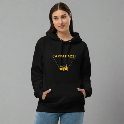 Woman wearing black hoodie with yellow carparazzi and camera design