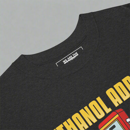 A closeup of a crewneck tshirt with ethanol addict and gas pump design