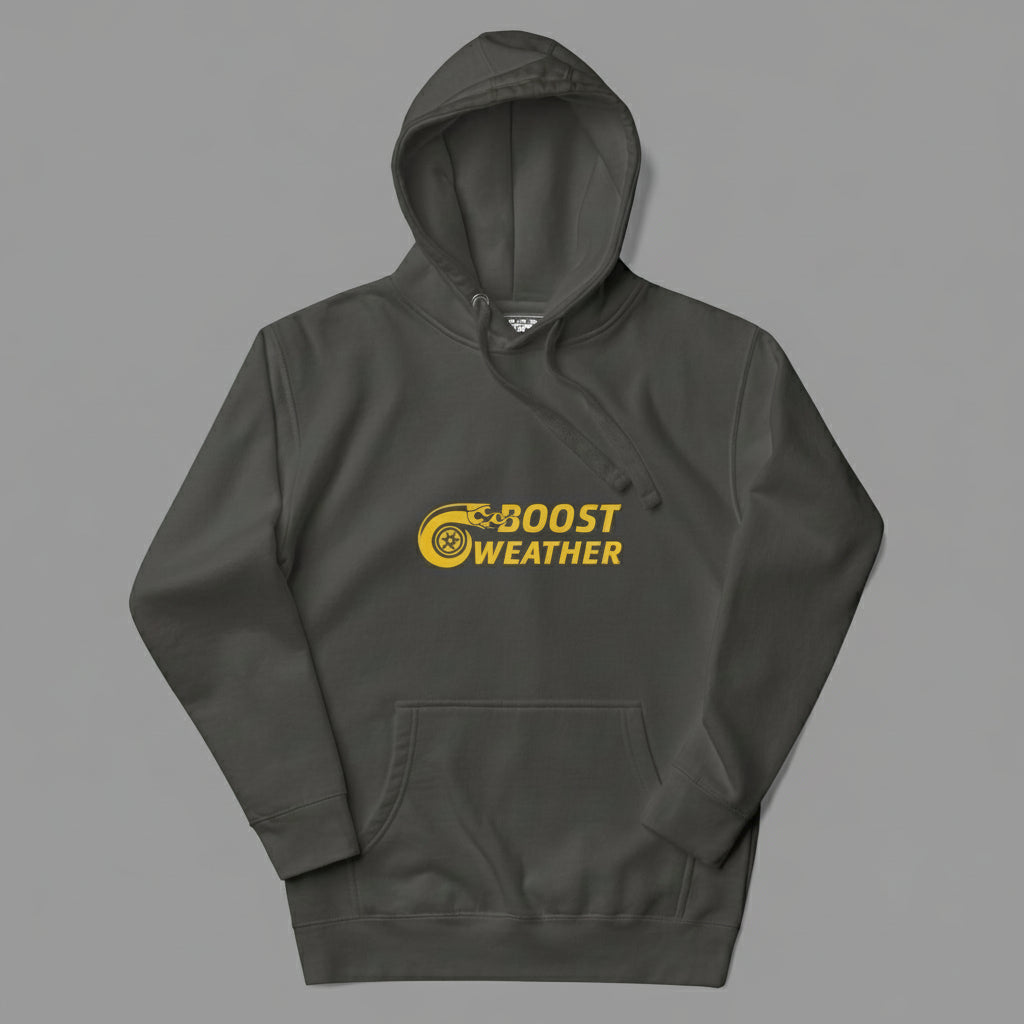 Flat lay of a hoodie in a gray that looks like a faded black color, with a gold design featuring the phrase Boost Weather and a tire with fire design next to it.