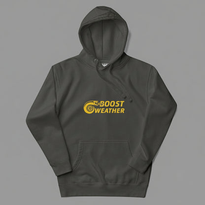 Flat lay of a hoodie in a gray that looks like a faded black color, with a gold design featuring the phrase Boost Weather and a tire with fire design next to it.