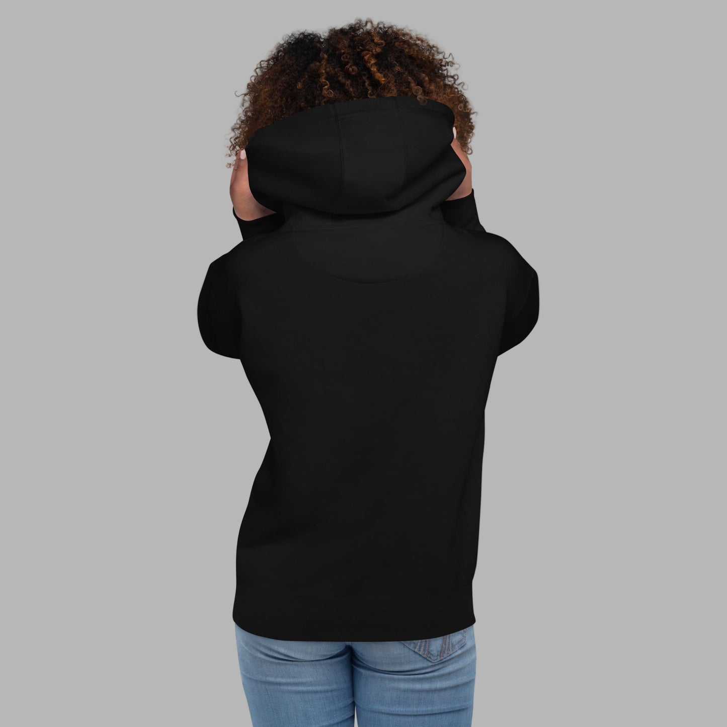 Person wearing a black hoodie on a gray background