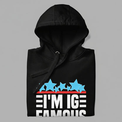 closeup of a black hoodie showing hood, flat drawstring, and design