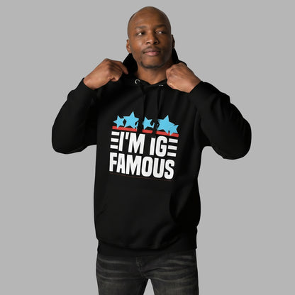 man wearing black i'm IG Famous hoodie with white lettering and blue stars.