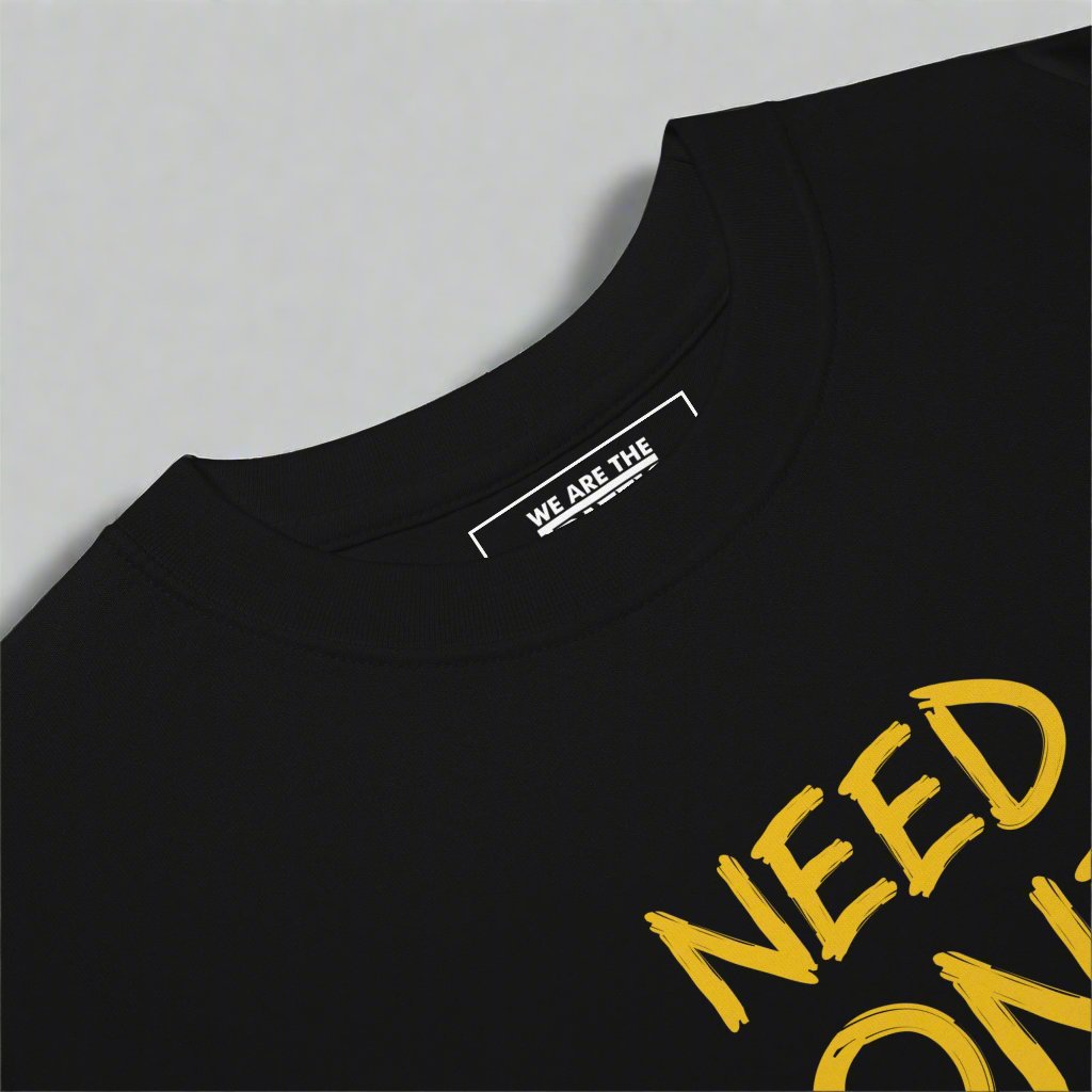 crewneck of a black t-shirt with gold design